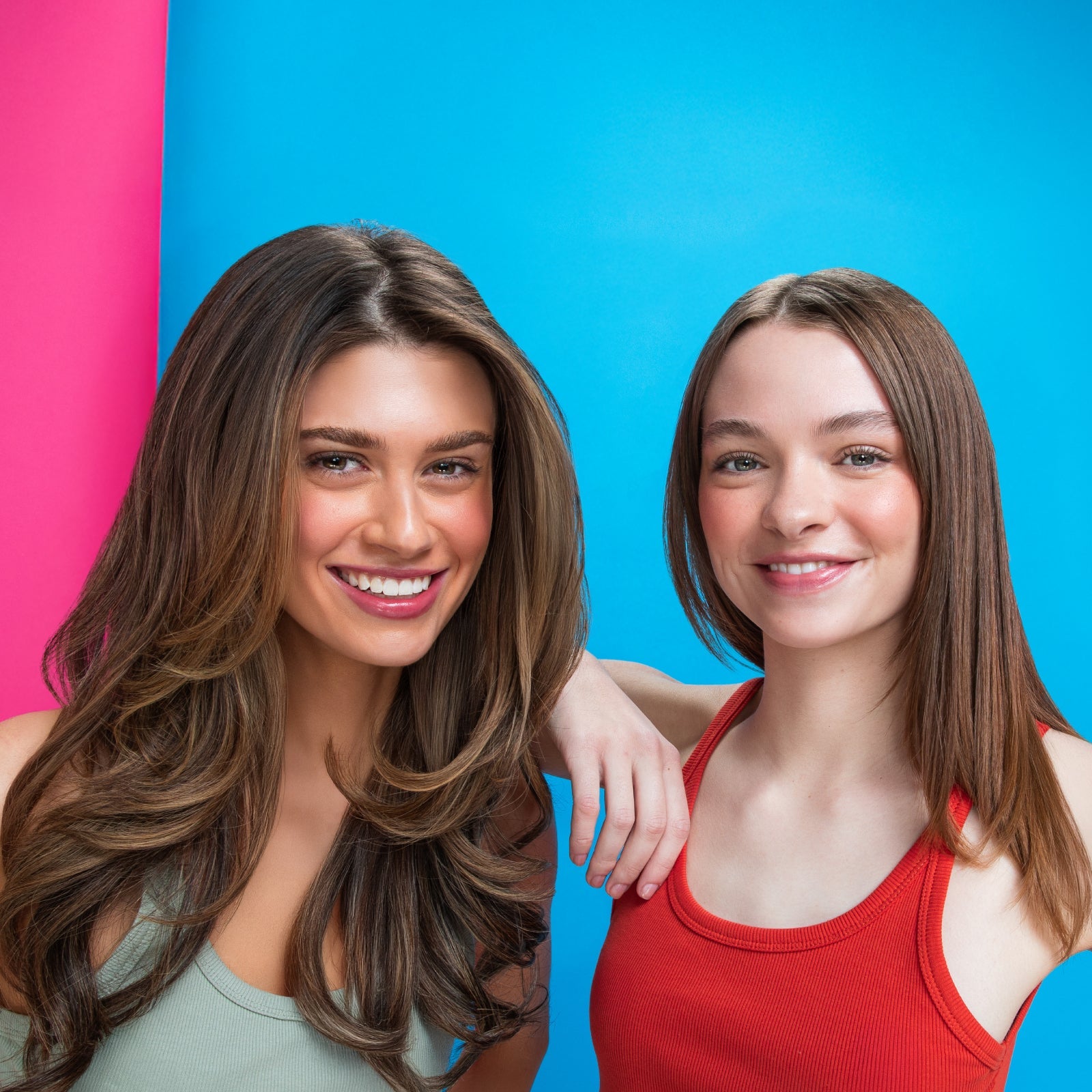 two smiling gen z women with healthy flowing hair