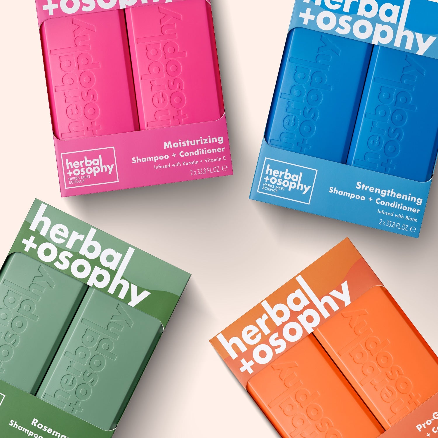four vibrant herbalosophy kits laying flat on a cream colored background