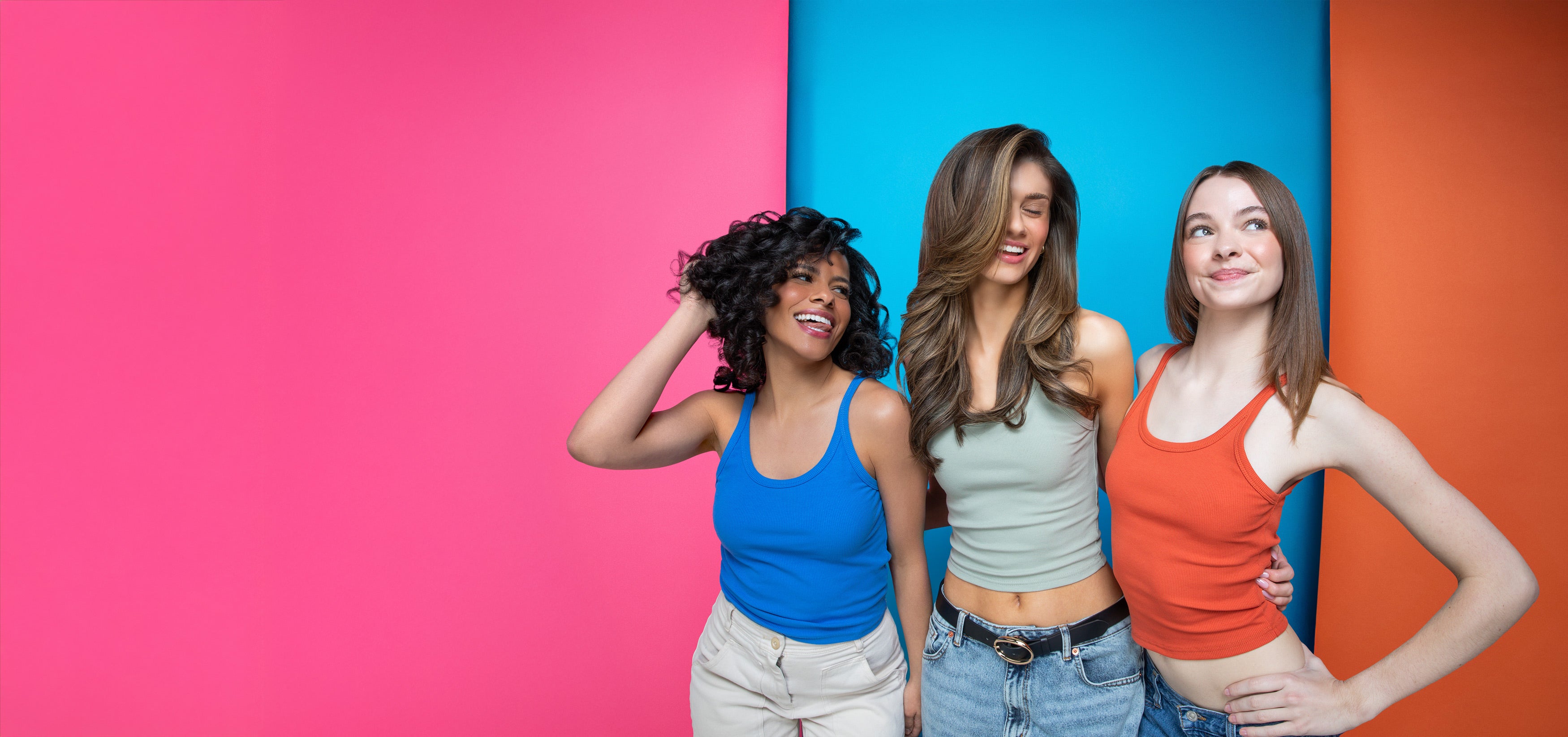three happy gen z women with flowing healthy stylish hair