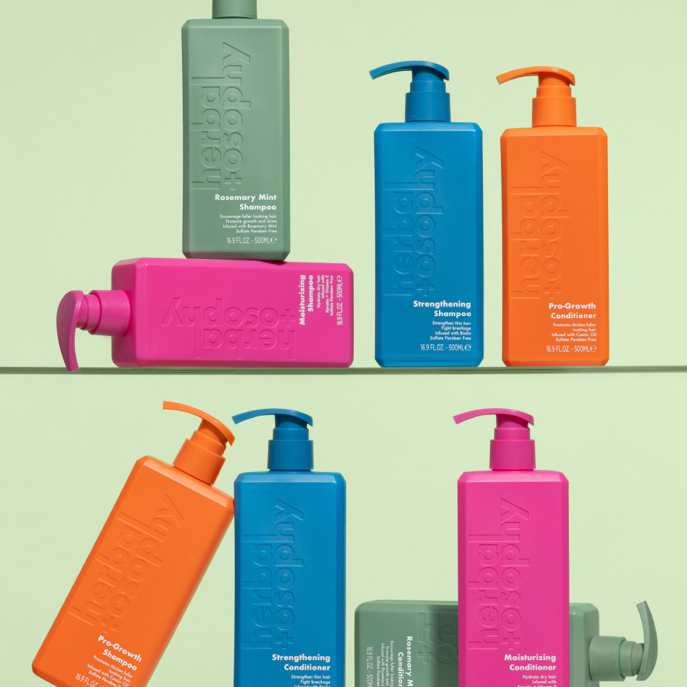 various vibrant Herbalosophy products sitting on a glass shelf