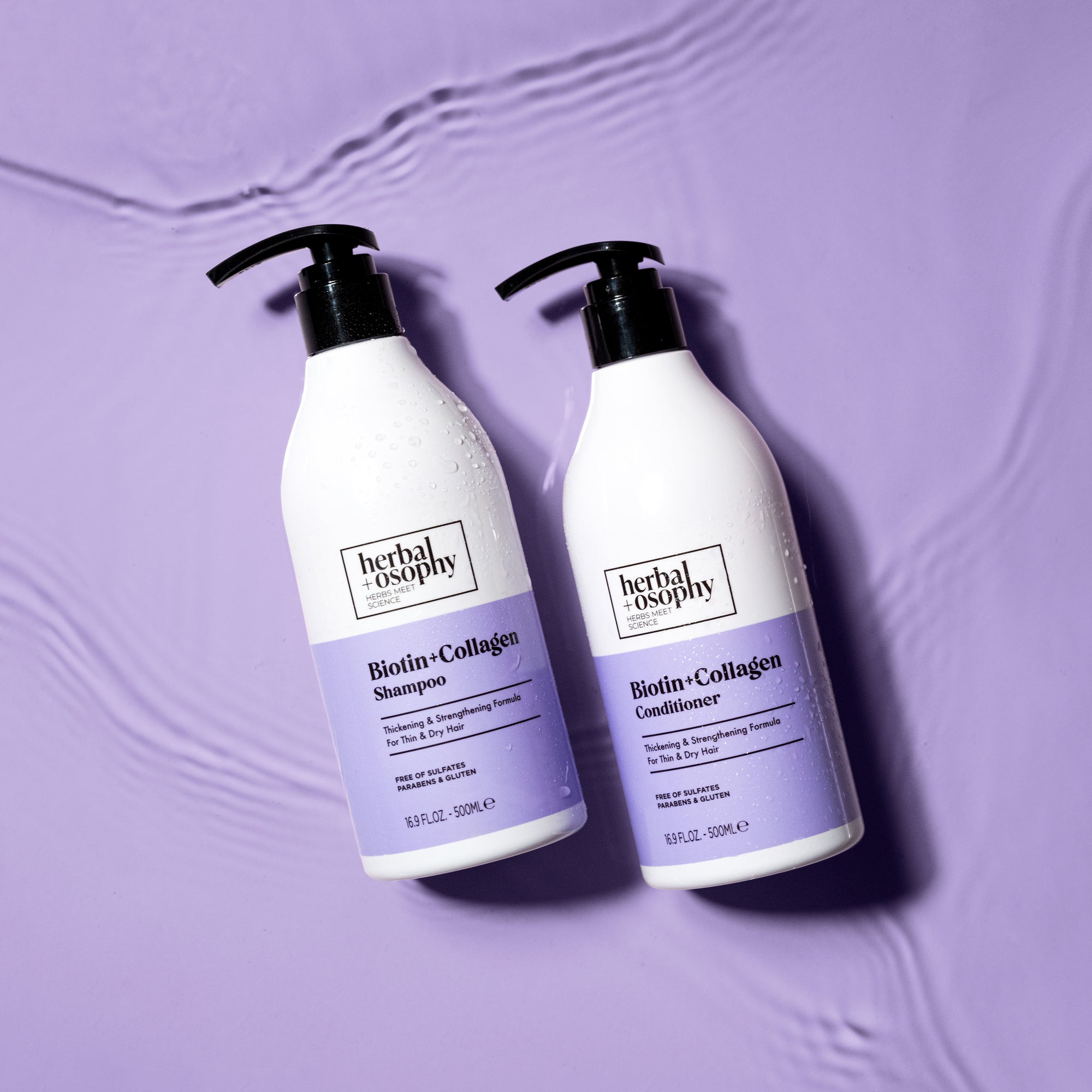 Biotin + Collagen Shampoo and Conditioner bottles on purple background with rippling water