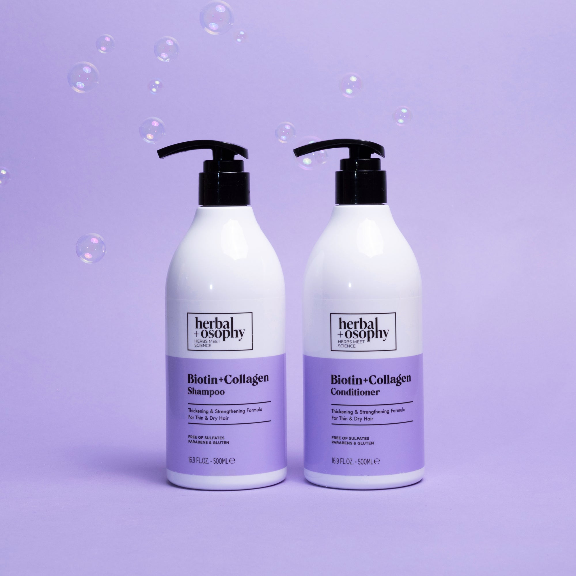Biotin + Collagen Shampoo and Conditioner bottles on a purple background with bubbles